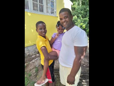 
11-year-old Fytzroi Robinson with his six-year-old sister Quirina Robinson and father, Fitzroy Robinson
