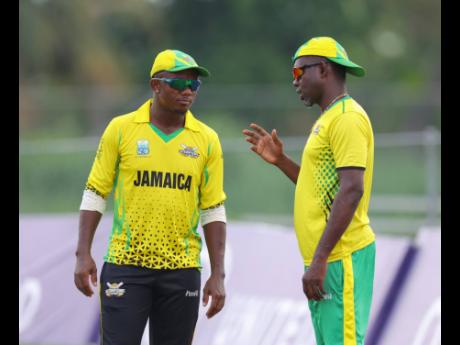 CWI 
Jamaica Scorpions’ assistant coach Nikita Miller (right) chats with Andre McCarthy during their Super50 Cup game against the Barbados Pride on October 20.