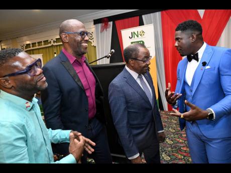 Rudolph Brown/Photographer Nick Perry (second right),  United States ambassador to Jamaica, speaks with (from left) Ricky Pascoe, president of Jamaica Network of Seropositives; Ivan Cruickshank, executive director of Caribbean Vulnerable Communities; and J