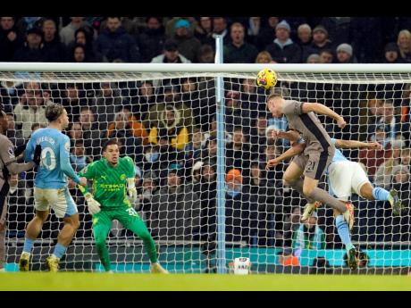 Tottenham’s Dejan Kulusevski (foreground right)  scores his side’s third goal during the English Premier League  match between Manchester City and Tottenham Hotspur at Etihad stadium in Manchester, England, yesterday.