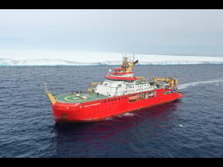 In this handout photo provided by the British Antarctic Survey, the RRS Sir David Attenborough in front of A23a iceberg in Antarctica on Friday, December 1. Britain’s polar research ship has crossed paths with the largest iceberg in the world in a “luc