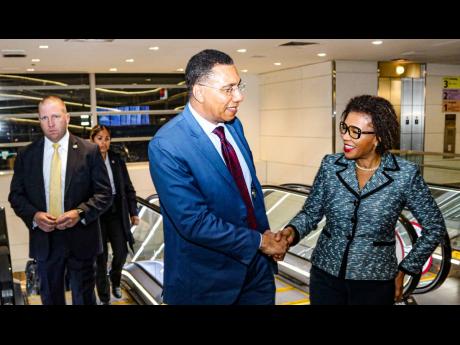 Prime Minister Andrew Holness is met on arrival at the Ronald Reagan International Airport in Washington DC on Monday by Jamaica’s Ambassador to the United States Audrey Marks.