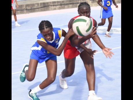 The Queen’s School’s Shemesh Wallace (right) and St Hugh’s Yanique Bond compete for the ball during an ISSA urban junior netball semifinal match at the Leila Robinson Courts last Friday.