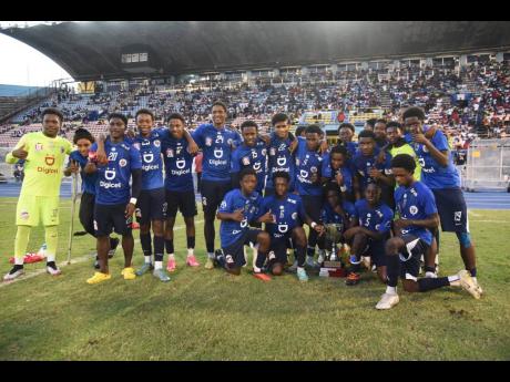 Jamaica College players celebrate winning the Walker Cup knockout competition after a 7-6 penalty win over ST Andrew Technical High School inside the National Stadium earlier this evening.