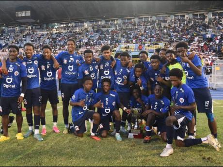 Jamaica College players celebrate victory in the Walker Cup KO competition after defeating St Andrew Technical High School 7-6 in a penalty shoot-out  inside the National Stadium yesterday.