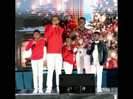 Romaine Virgo (second right) delivers a medley of ‘I’ll be Home for Christmas’ with the Mitchell boys (sons of Tami and Wayne) and outstanding nine-year-old soprano, Je’rard Hall (right)).