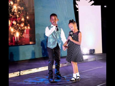 Atlas Mitchell (left) and Arya Chin give an adorable performance at VoiceBox's Four Seasons of Christmas.