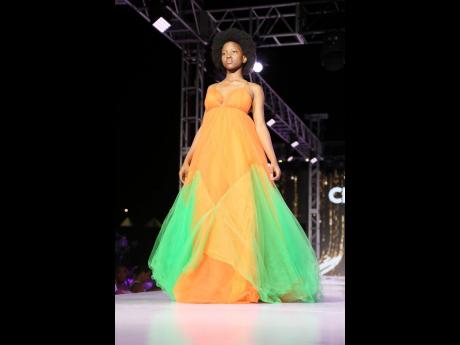 
Clee Designz gave the Barbie girl in a style world a new natural meaning, stunning the audience with the gorgeous orange dress adorned with streams of green.