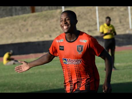 Tivoli’s Justin Dunn celebrates after scoring against Dunbeholden in their Jamaica Premier League match at the Stadium East field yesterday. 