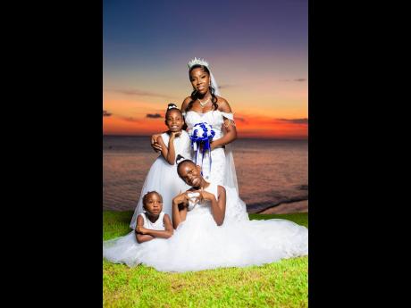 Here comes the beautiful bride, accompanied by her precious mini brides, Tiandra Harrison (left) Nickese Coleman (front left) and Khamika Harrison. 