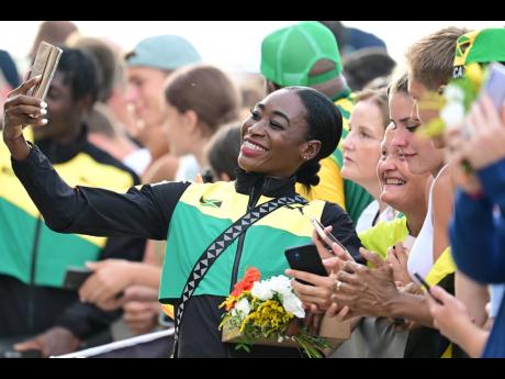 Bronze medallist in the 400m women’s hurdles, Rushell Clayton, takes photos with track and field fans moments after the medal presentation at the 2023 World Athletics Championships held at the National Athletics Centre in Budapest, Hungary, on August 25.
