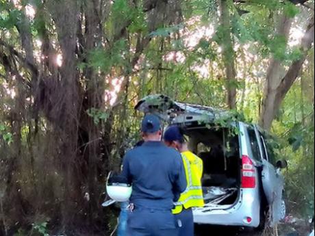 Police processing the accident scene in Bluefields, Westmoreland on Monday, November 13 following the motor vehicle collision which resulted in the death of five people. Delroy Rodney, who was driving the taxi in which the five people perished, is facing t