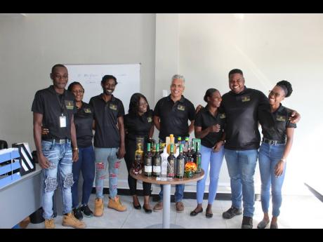 Peter Wong (fifth left), general manager at Royal Jamaican Rums and Spirits, and some of his staff members (from left), Everton Carthy, inventory supervisor; Shenele McDonald, excise officer; Richard Halledeen, brewer; Golda-Gay Arnold, administrative mana