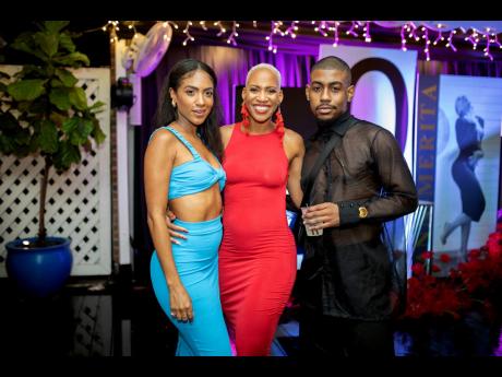 Sandwiching the birthday girl in radiant red are ‘Paradise Plum’ singer, Naomi Cowan (left), and social media influencer and host, Rushane ‘RushCam’ Campbell. 
