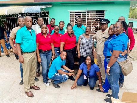 Senior Superintendent  of Police Howard Chambers with a team from the Centre for Investigation of Sexual Offences and Child Abuse at Strathmore Gardens Children’s Home last Wednesday. 