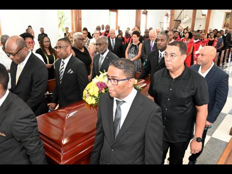 Pallbearers (clockwise, from left) Courtney Cole, Alphonso England, Don Anderson, Les Baugh, Kasey Bourne and Kurt Wedderburn carry the coffin at the service of thanksgiving for Professor Edward Alston Cecil Baugh at The University Chapel at The University