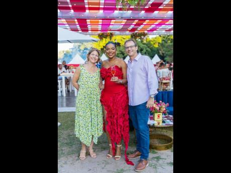 From left: Tania McConnell of Select Brands, Scotia Investments’ Tameka Peru, and David McConnell are in high spirits, indulging in an evening of elegance. 