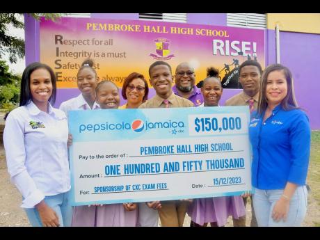 From left: Anecia Levy, Pepsi Cola Jamaica Transformation Manager, and (right) Bianca Fakhourie, Pepsi Cola Jamaica Corporate and Legal Specialist, present a cheque of $150,000 to Pembroke Hall High School to assist with payment of Caribbean Examination Co