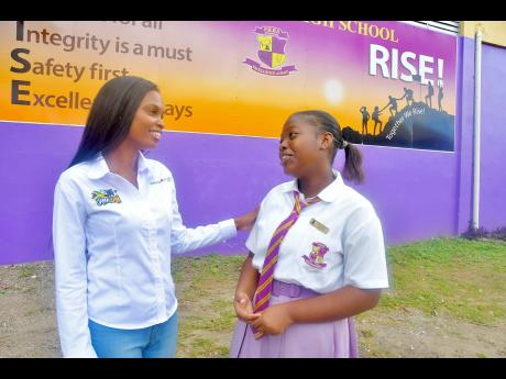  Anecia Levy (left), transformation manager at Pepsi Cola Jamaica, listens intently to Pembroke Hall High School student Nakaila Meirs.