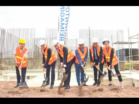 Prime Minister Andrew Holness (third left) participates in Tuesday's 19) groundbreaking exercise for Sherbourne Limited's $2.1-billion Kingston 2 apartments in Bournemouth Gardens. He is joined by (from left) BYD Construction CEO Richard Xin; Richard Lake,