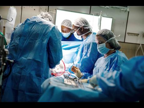 A team of doctors performs the first-ever ALPACA surgery at the Bustamante Hospital for Children in St Andrew, Jamaica, on Wednesday, November 29.