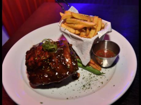 Feast your eyes and then your taste buds on a full rack of baby back barbecued ribs, starring in the show with its trusted sidekick, French fries.