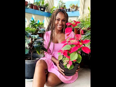 ‘Tis the season to be jolly with poinsettias, and plant mom Stephanie Wallace basks in the welcoming red leaves just in time for the season.