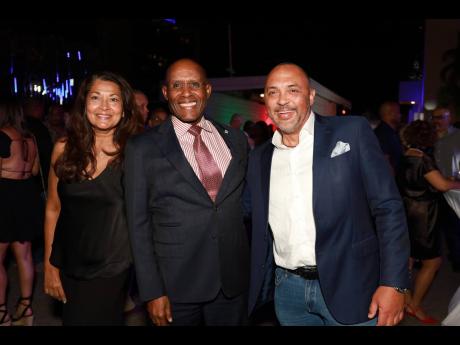 Senator Aubyn Hill (centre), minister of industry, investment, and commerce, is joined by his wife, Tamara and Charles Chambers for a brief photo op.