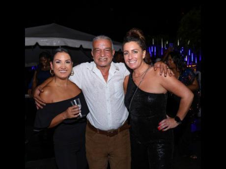 Captain Hamada Fouda of Maritime Authority of Jamaica is flanked by two beauties, Arnella Goubault (left), executive support manager, and Dearbhla Kieran, commercial manager, both from West Indies Petroleum.