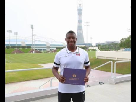 Miguel Coley proudly shows off his UEFA Pro Licence badge.