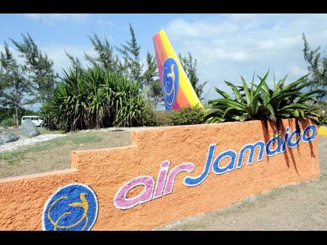 File photo showing the Air Jamaica sign and tail of an aircraft with the Lovebird sign at the Norman Manley International Airport roundabout.