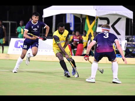 Tyrone Vernon (centre) of Jamaica in action against Michael Barminski Jr (right) and Jatin Sharma of the United States during the 2023 Hockey5s Pan American Cup qualifying tournament at the Mona Hockey Field on Sunday, June 4, 2023.