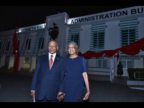 Sir Kenneth Hall stand outside the administrative building of The University of the West Indies, Mona, which was renamed in his honour, alongside his wife.