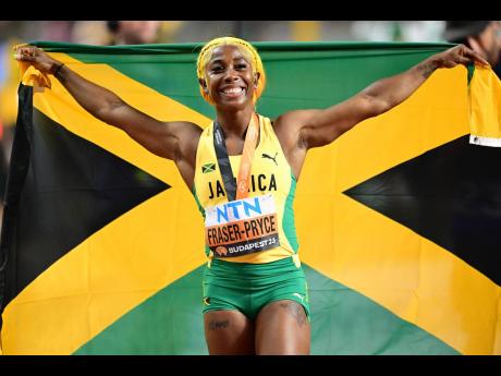 Shelly-Ann Fraser-Pryce of Jamaica celebrates a bronze medal in the women’s 100 metres at the 2023 World Athletics Championships at the National Athletics Centre in Budapest, Hungary on August 21. 