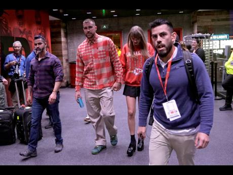 Kansas City Chiefs tight end Travis Kelce (centre left) and singer Taylor Swift leave Arrowhead Stadium after an NFL game between the Chiefs and the Los Angeles Chargers on October 22, 2023, in Kansas City.