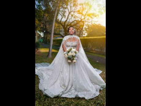 The beautiful bride adorned an exquisite ivory A-line dress with a sweetheart neckline, lace, and pearls. It was complemented by a stunning over-the-shoulder high neckline cape with lace and cascading pearl details, from LuxBrides Ja.