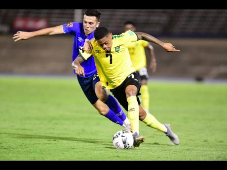 Jamaica’s Leon Bailey (right) dribbles  past El Salvador’s Luis Vasquez  during a Concacaf World Cup Qualifier  at the National Stadium on Thursday, March 24, 2022. 