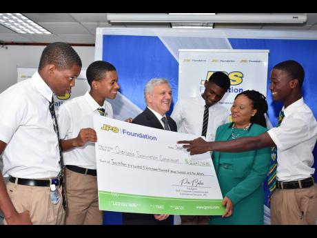 JPS Chairman Damian Obiglio (3rd left) is all smiles at the official handover ceremony of the JPS Foundation’s grant- funding of approximately $2.6m to cover exam fees for students sitting the CSEC electrical exam in 2024.  Taking a closer look at the sy
