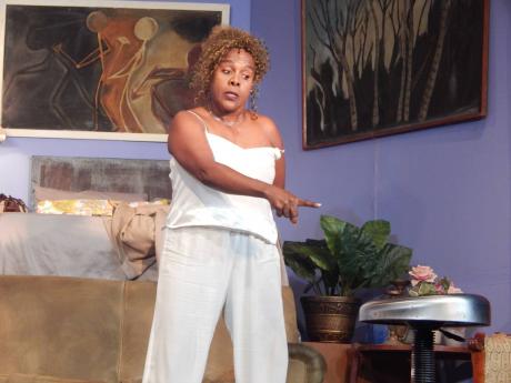 Millicent (Deon Silvera) gestures dramatically as she addresses an invisible company chairman.