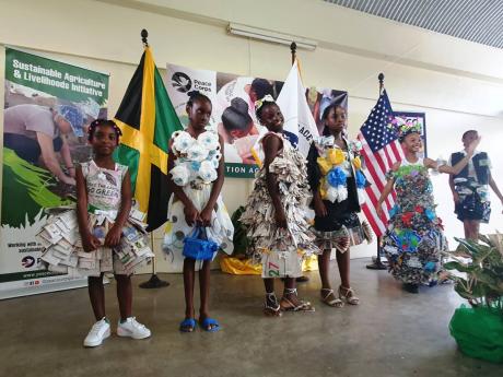 
School children participate in a fashion show with dresses made out of recycled material at Peace Corps Jamaica Environment Expo.