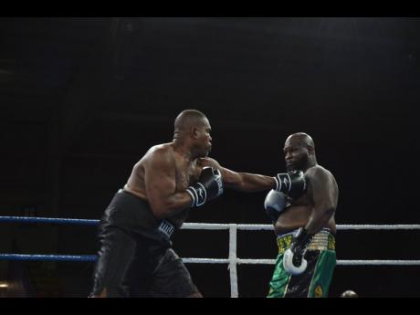 Donovan ‘Razor’ Ruddock (left) battles with James ‘Lights Out’ Toney during their charity boxing match dubbed ‘Rumble In The Sun’ at the National Arena on Saturday, November 10 2023.  