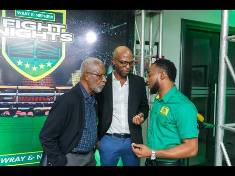  Jamaica Boxing Board general secretary Leroy Brown (left) Jamaica Boxing Board president, Stephen Jones (centre) and Wray & Nephew White Overproof Rum, marketing manager Pavel Smith  talk boxing during the Wray & Nephew Fight Nights launch held June 21 at
