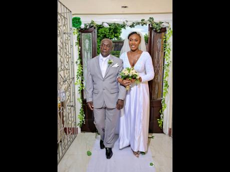 The blushing bride, accompanied by her father, Lloyd Pottinger, is gracefully escorted up the aisle, poised to meet her handsome groom at the altar.