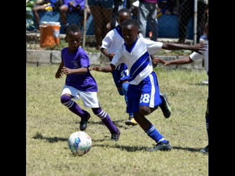 Sts Peter and Paul (left) and St Aloysius in action in the Junior Cup under-nine semi-final at the Constant Spring Field on April 3, 2023.