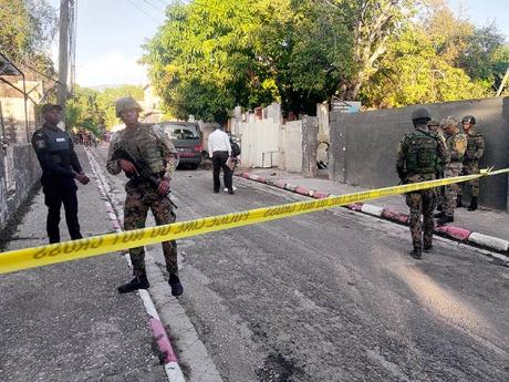 Members of the security forces man the scene on 100 Lane off Red Hills Road, following protests by residents over the fatal shooting 14-year-old Rasheem Wilson yesterday. Story on A32.