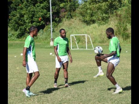 Jourdaine ‘Jay Jay’ Fletcher (centre) returns to Montego Bay United after playing in Albania and is joined in training this morning by fellow Jamaican Courtney Allen (left) and Trinidad and Tobago’s Darnell Hospedales. The three are among seven playe