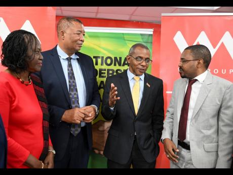 Pastor Claudia Ferguson, vice-chair of the National Leadership Prayer Breakfast (NLPB) Committee; NLPB Chair Rev Sam McCook (second left) and Paul Lewis, (right), general secretary of the Student Christian Fellowship and Scripture Union, give their attenti