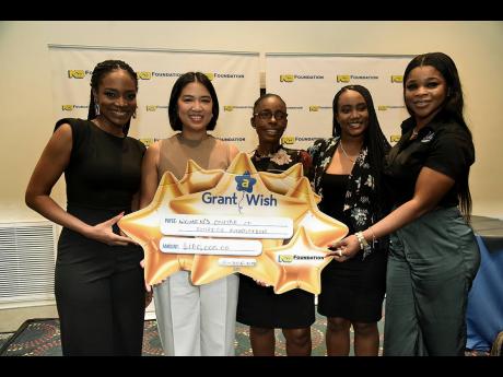 Natalie Fuller (centre), projects coordinator, the Women’s Centre of Jamaica Foundation (WCJF), and Georgia Thompson (second right), WCJF counsellor,  were pleased to receive a cheque for the Beauty and the Brain Grant A Wish initiative, spearheaded by M