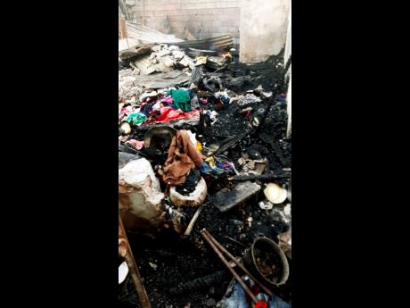 The charred remains of clothing and other items at premises located at 3 (1/2) and  4 Swettenham Road in Whitfield Town, Kingston 13, which were gutted by fire on Wednesday, leaving 25 people, including children homeless.