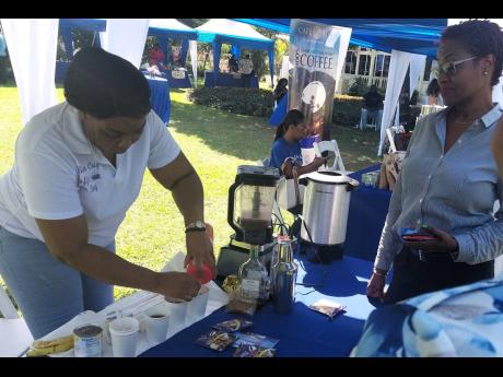 Tanesia Brown prepares a cup of Betta Cup coffee for a customer who eagerly anticipates tasting the hot beverage. Occasion was Tuesday’s launch of the 2023 Jamaica Blue Mountain Coffee Festival at the Edward Seaga Suite, Devon House. The festival will ta